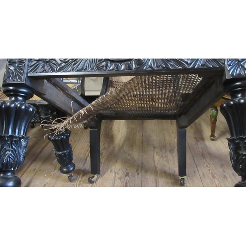 79 - A pair of 19th century possibly ebony or coromandel, Anglo Indian arm chairs with part carved frieze... 