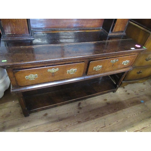 82 - A 19th century oak pot board dresser with open delft rack over two fitted cupboard drawers and two d... 