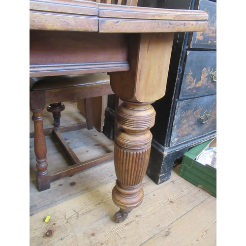 34 - An Edwardian extending dining table raise on four reeded legs, width 47ins, length 92ins