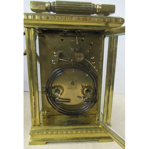 144 - A brass cased repeating carriage clock, with enamel dial and Roman numerals