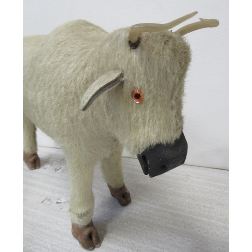 174 - A plush covered model of a bull, height 11ins