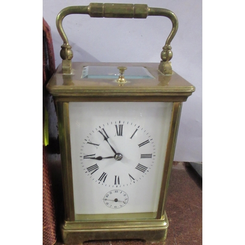 202 - A brass cased repeating carriage clock, with subsidiary dial, together with leather covered travel c... 