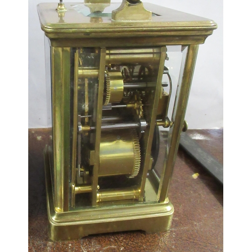 202 - A brass cased repeating carriage clock, with subsidiary dial, together with leather covered travel c... 