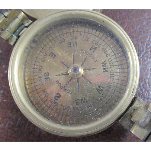 230 - W E Pain & Son, a brass cased pocket barometer, in leather covered case, together with a Cooke Londo... 