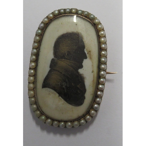 270 - John Field, A Georgian portrait silhouette, of a man, signed, in a yellow metal brooch mount set wit... 