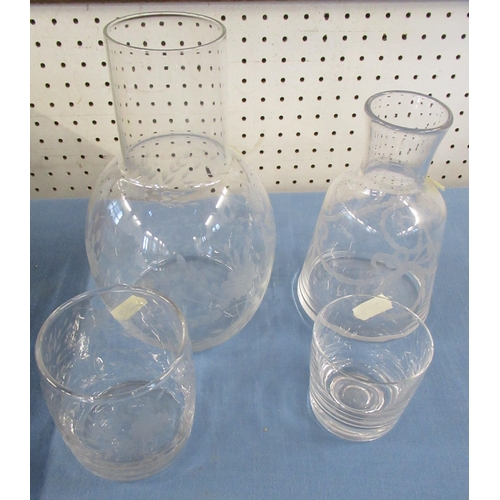 311 - A set of eight wine glasses, with etched vine pattern, together with two glass water carafes and bea... 