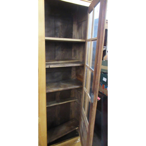 49 - A satin birch bookcase with moulded cornice and fitted pair of glazed and panelled doors below on br... 