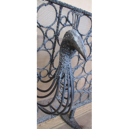 61 - A metal and wire fire spark guard, with peacock head decorations, height 28ins, width 39.5ins