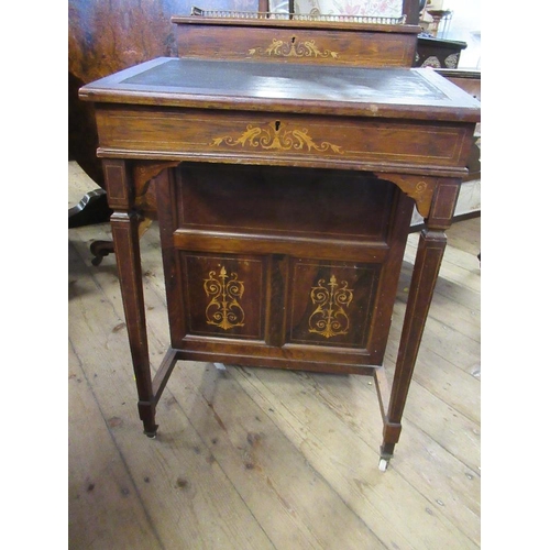 72 - An Edwardian rose wood Davenport fitted with four drawers and dummy drawer below a raising stationar... 