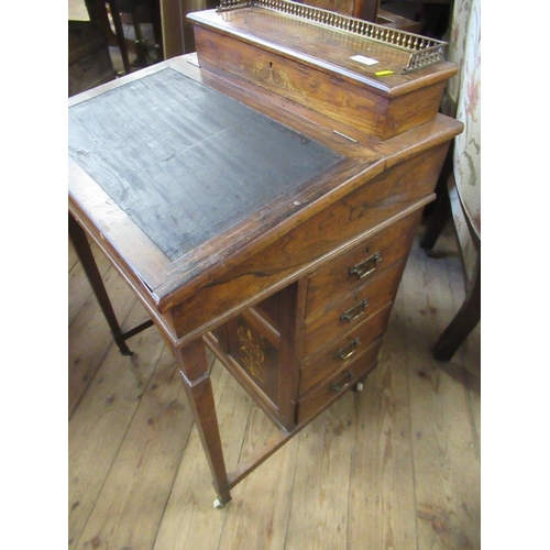 72 - An Edwardian rose wood Davenport fitted with four drawers and dummy drawer below a raising stationar... 