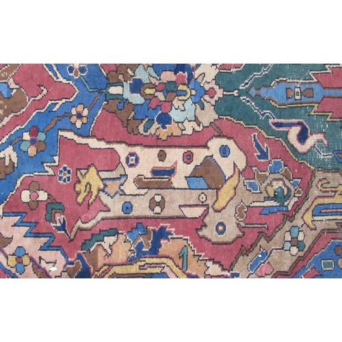 76B - A large Eastern design rug, the field decorated with stylised animals and flowers, with Made in Turk... 