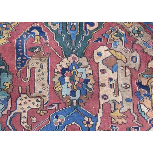 76B - A large Eastern design rug, the field decorated with stylised animals and flowers, with Made in Turk... 