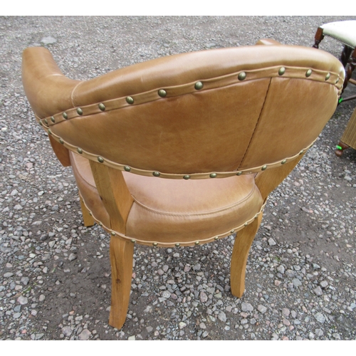 99A - A modern open armchair with leather seat and back