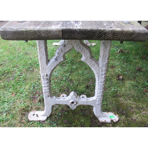 95 - A wrought iron and wooden bench together with a table