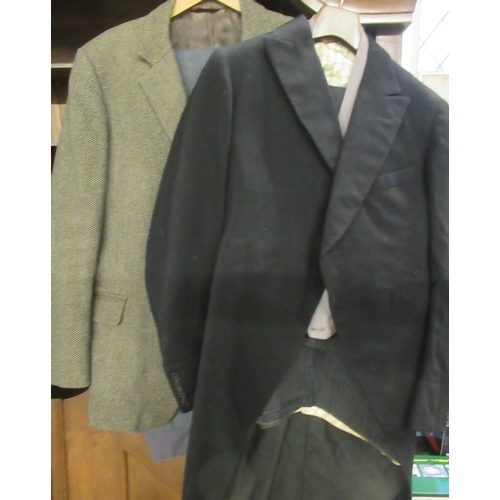 392 - A collection of clothing, to include suit, green long coat, jacket etc