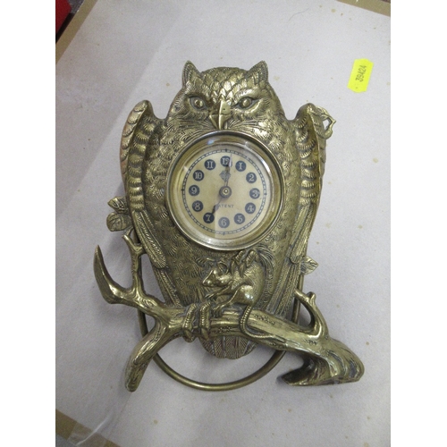 132 - British United Clock Co. Ltd, a brass mantel clock modelled as an owl with mouse in its claws, on a ... 