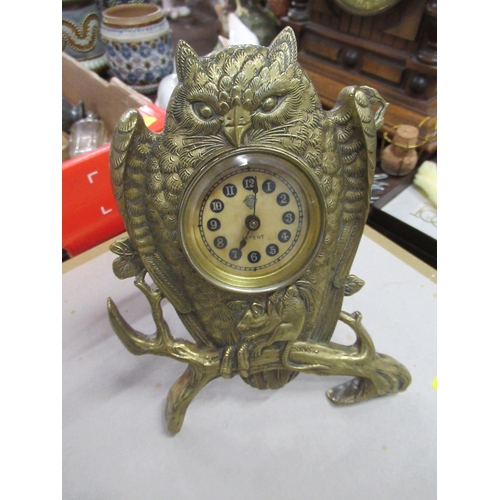 132 - British United Clock Co. Ltd, a brass mantel clock modelled as an owl with mouse in its claws, on a ... 