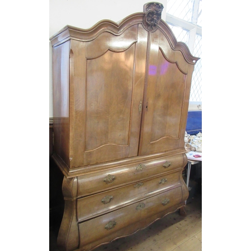 1 - A 19th century Dutch armoire,  the upper section having two drawers opening to reveal  shelves over ... 