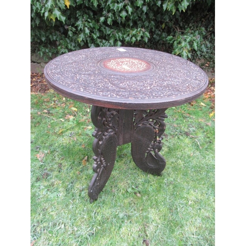 10 - An eastern design covered occasional table, diameter 18ins, height 19ins