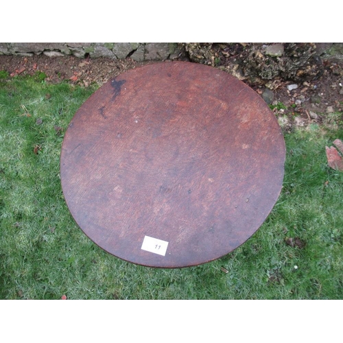 11 - A primitive cricket table, raised on three slender legs diameter 16ins, height 27ins