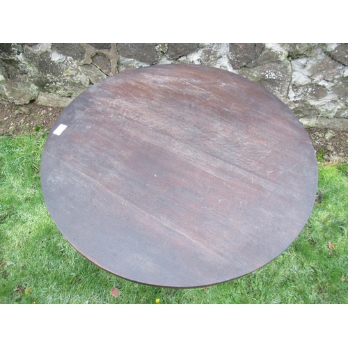 13 - An oak circular top cricket table raised on three turned legs united by stretchers diameter 29ins, h... 