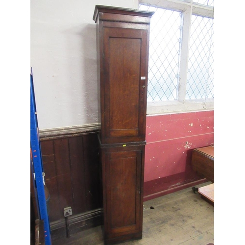 16 - An antique narrow cupboard having two fitted sections with fielded doors,  width 18ins, height 87ins