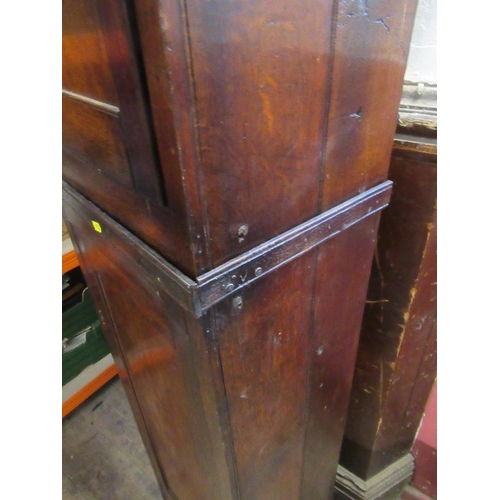 16 - An antique narrow cupboard having two fitted sections with fielded doors,  width 18ins, height 87ins