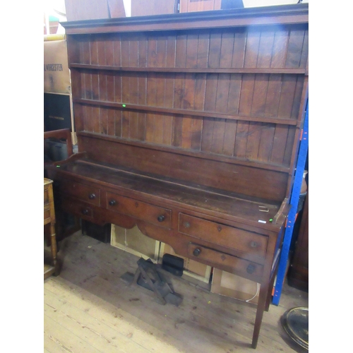 19 - An antique oak dresser, having boarded plate rack over, dresser base fitted with three short drawers... 