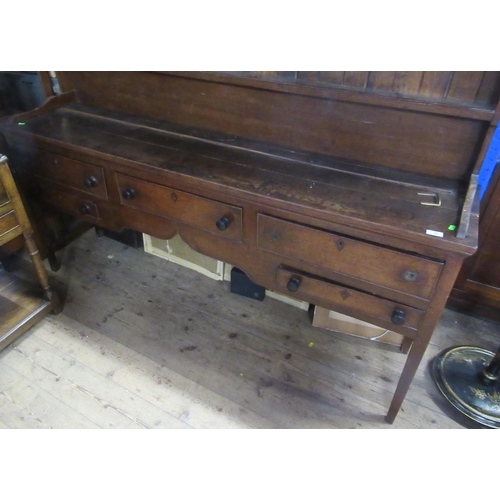 19 - An antique oak dresser, having boarded plate rack over, dresser base fitted with three short drawers... 