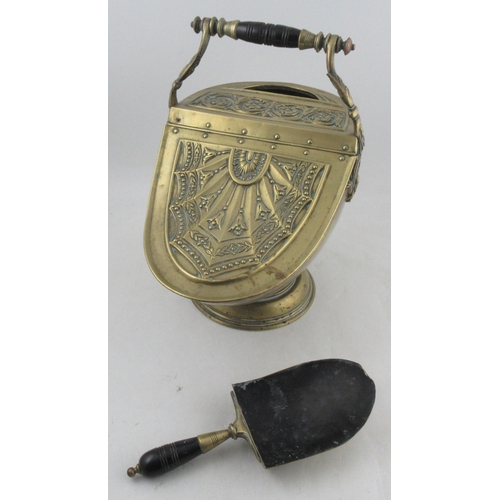 211 - A Victorian brass helmet shaped coal bucket and shovel, with raising lid harebell decoration, height... 