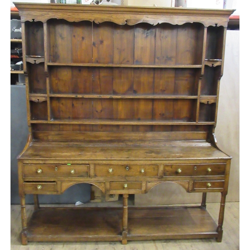 22 - An Antique oak dresser, the upper section fitted with shelves, the base fitted with six drawers, wit... 