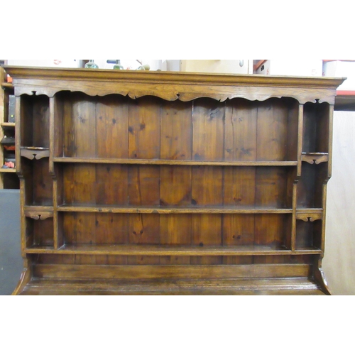 22 - An Antique oak dresser, the upper section fitted with shelves, the base fitted with six drawers, wit... 