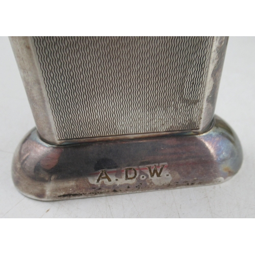 226A - A Dunhill silver mounted tallboy type lighter, with engine turned decoration, together with a set of... 