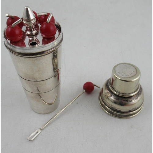 226A - A Dunhill silver mounted tallboy type lighter, with engine turned decoration, together with a set of... 