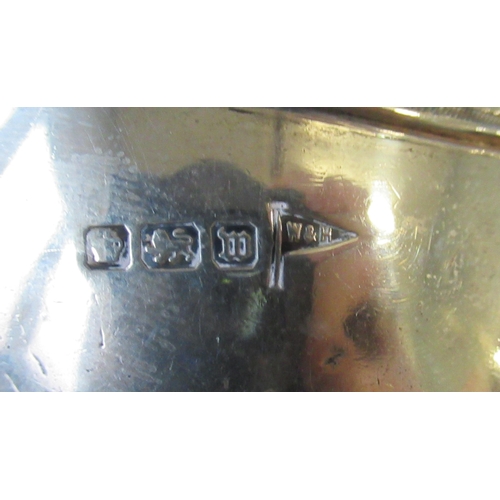 238 - A silver sauce boat, raised on a square pedestal foot, with Greek key borders and square scroll hand... 