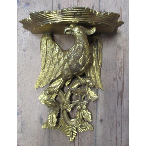 24 - A wooden gilt wall bracket, formed as a wing bird, on foliage supporting a shelf, 12.5ins x 16ins