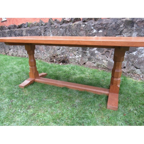 26 - A Robert Thompson Mouseman rectangular top dining table, raised on two octagonal legs on sledge feet... 