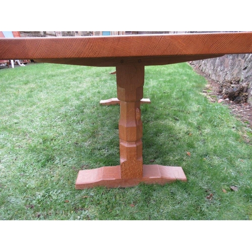 26 - A Robert Thompson Mouseman rectangular top dining table, raised on two octagonal legs on sledge feet... 