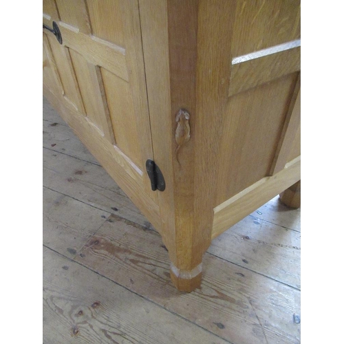 27 - A Robert Thompson Mouseman oak side board, having adzed top, with three graduated central drawers wi... 