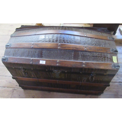 33 - A dome top trunk, having wooden bands and leather effect finish, width 32ins, height 24ins