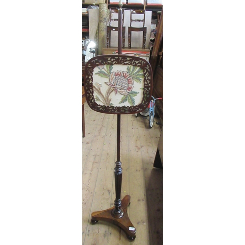 46 - A 19th century Regency rosewood pole screen, on tripartite base, with crewel work embroidered screen