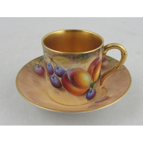 485 - A Royal Worcester coffee can and saucer, decorated with fruit by Roberts