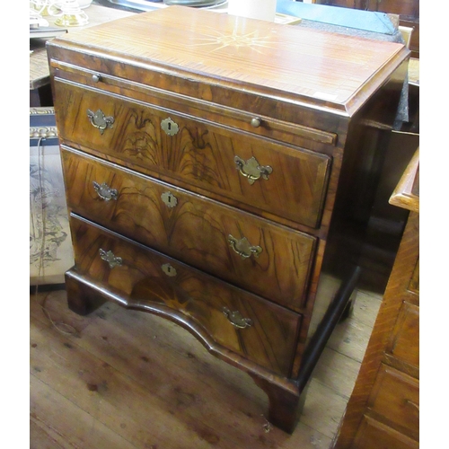 49 - A Georgian design caddy top chest of drawers, fitted with a brushing slide below a cross banded sunb... 