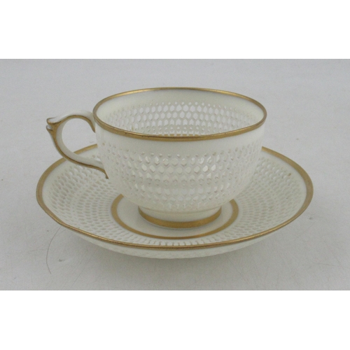 493 - A Royal Worcester cup and saucer, with finely pierced body by George Owen, with gilt banded rims