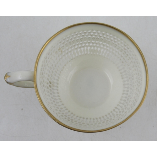 493 - A Royal Worcester cup and saucer, with finely pierced body by George Owen, with gilt banded rims