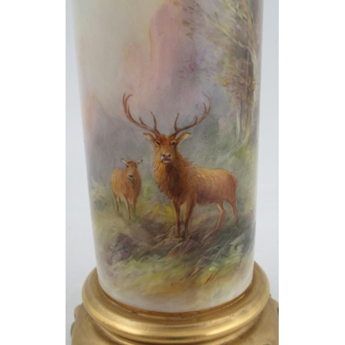 495 - A Royal Worcester cylindrical shaped vase, finely painted with a stag and a hind in a wooded landsca... 