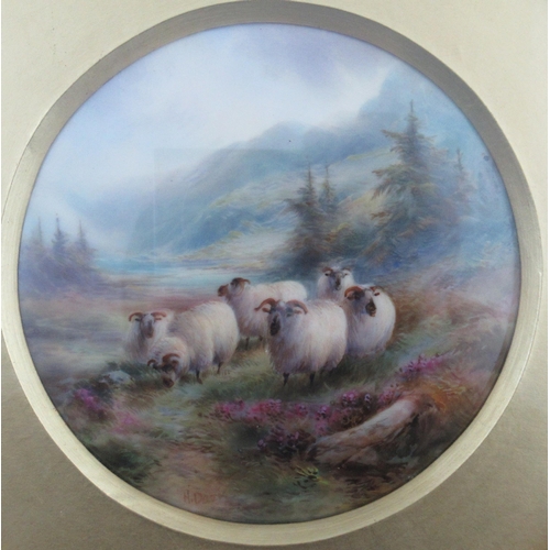 496 - A pair of Royal Worcester circular framed plaques, finely painted with sheep in a landscape with spr... 