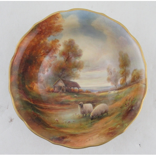 498 - A Royal Worcester bowl, the interior painted with sheep autumnal trees, water and a barn with a land... 