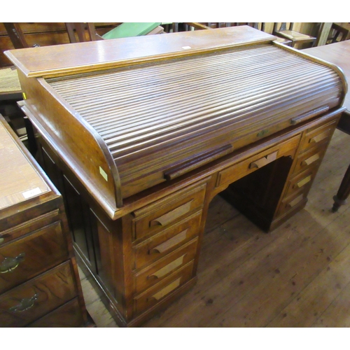 50 - An oak roll top desk, width 53ins, depth 32ins, height 38ins