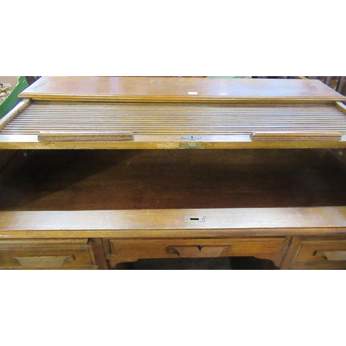 50 - An oak roll top desk, width 53ins, depth 32ins, height 38ins